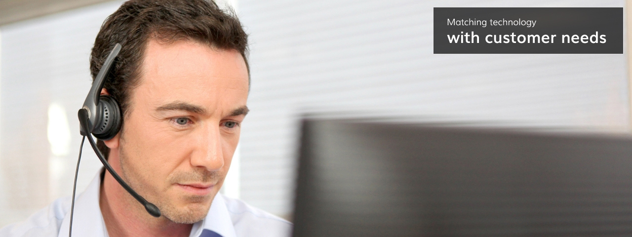 Man with a headset on talking to customers